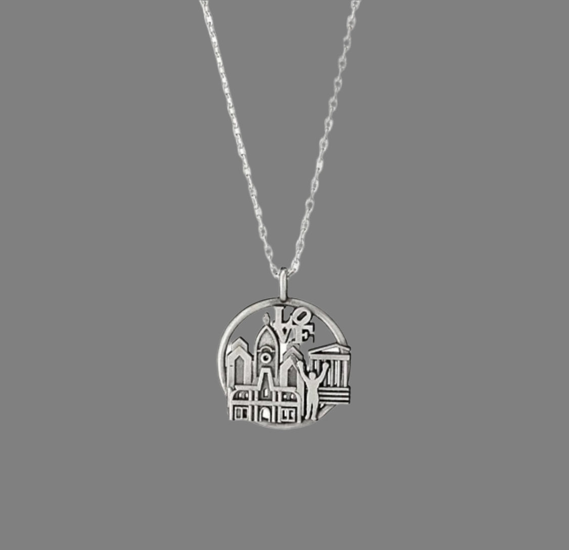 Silver necklace with a round pendant on a white background
