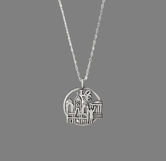 Silver necklace with a round pendant on a white background