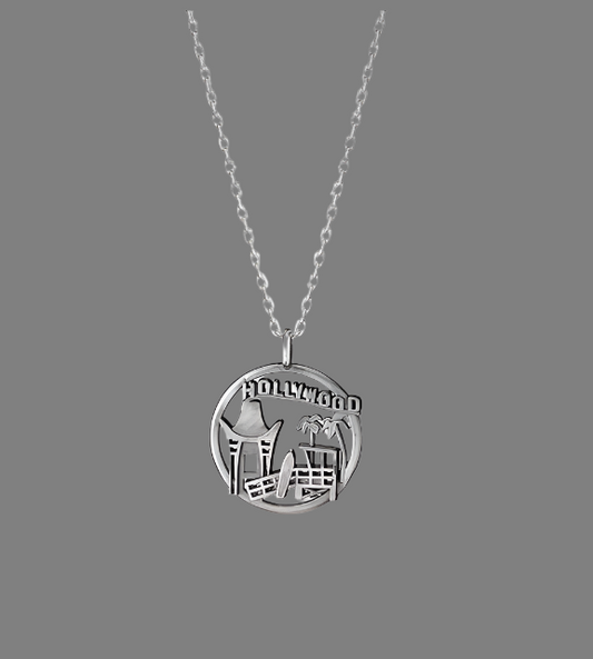 Silver necklace with a round pendant featuring the Hollywood sign on a white background