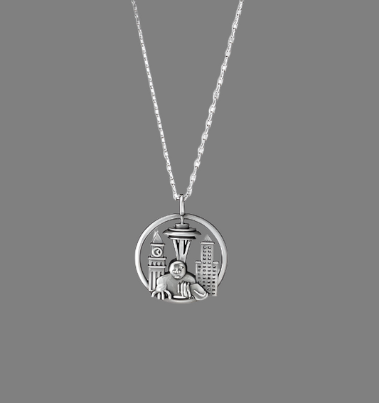Silver necklace with a pendant featuring a cityscape and a child, on a white background